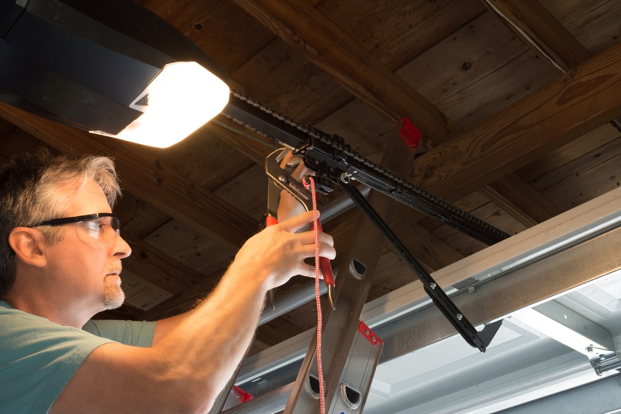 garage door repair guy fixing garage door